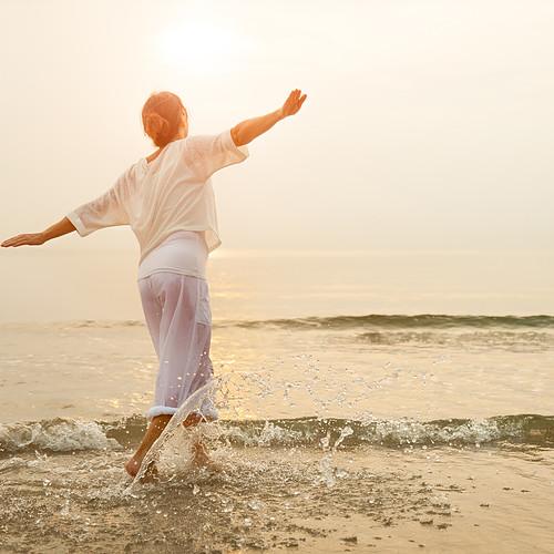 Woman dancing by the seaside